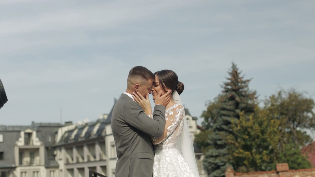 Bride and groom embracing outdoors